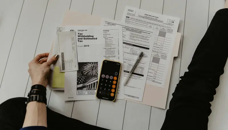 A desk with documents, an agenda and a cup of coffee