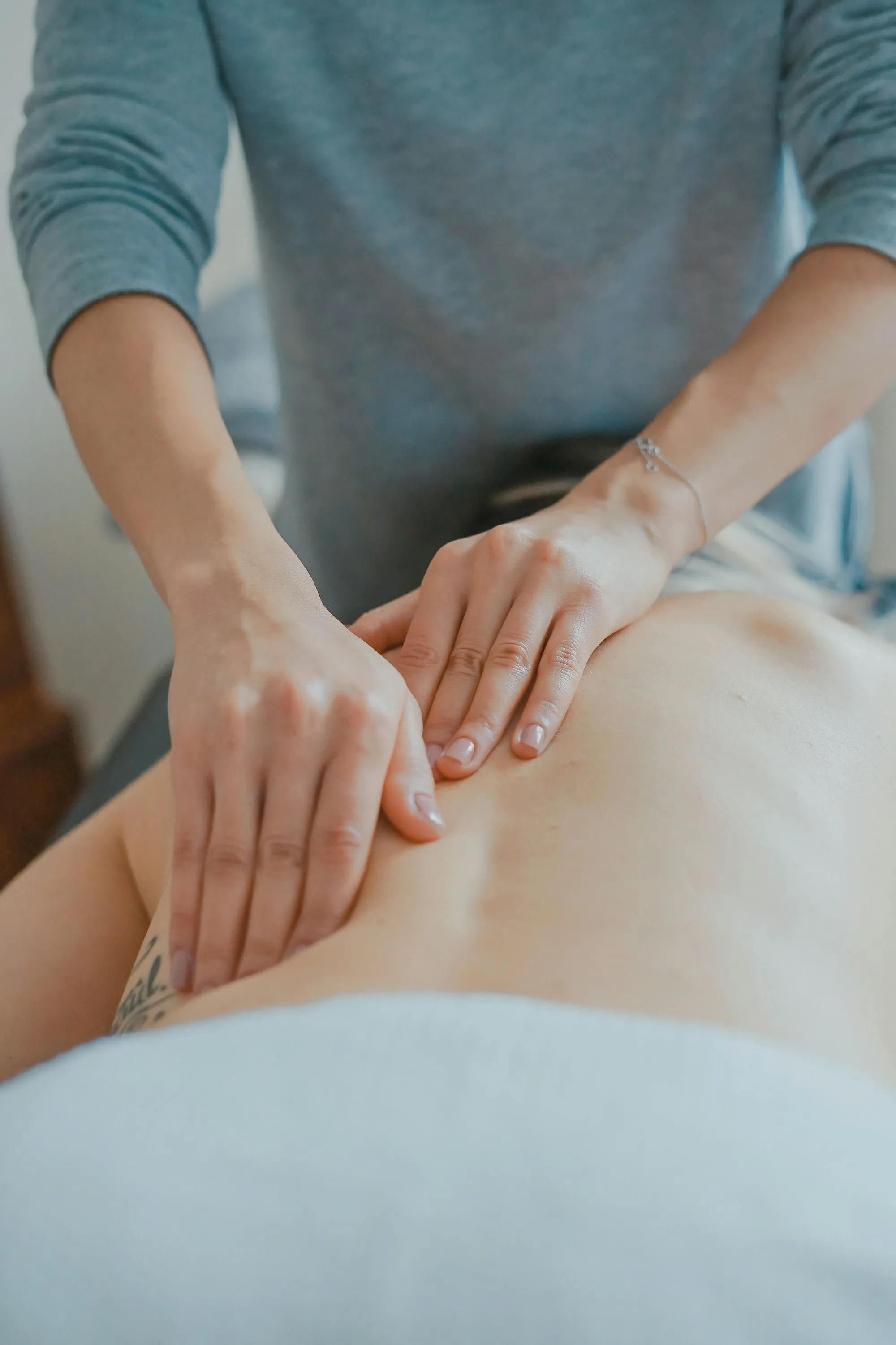 A complementary medicine practice website showing therapies, practitioner profiles and an online booking calendar