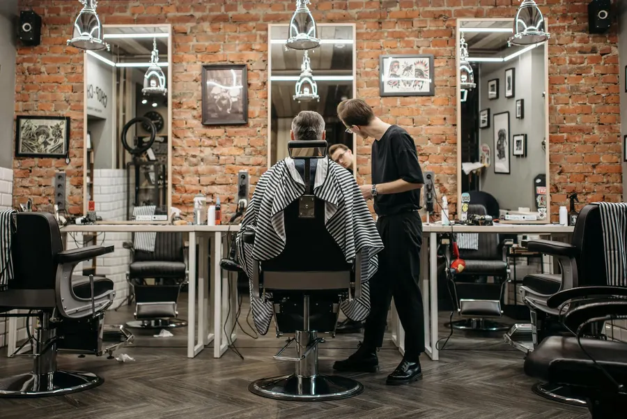 A barber at work on a faded cut